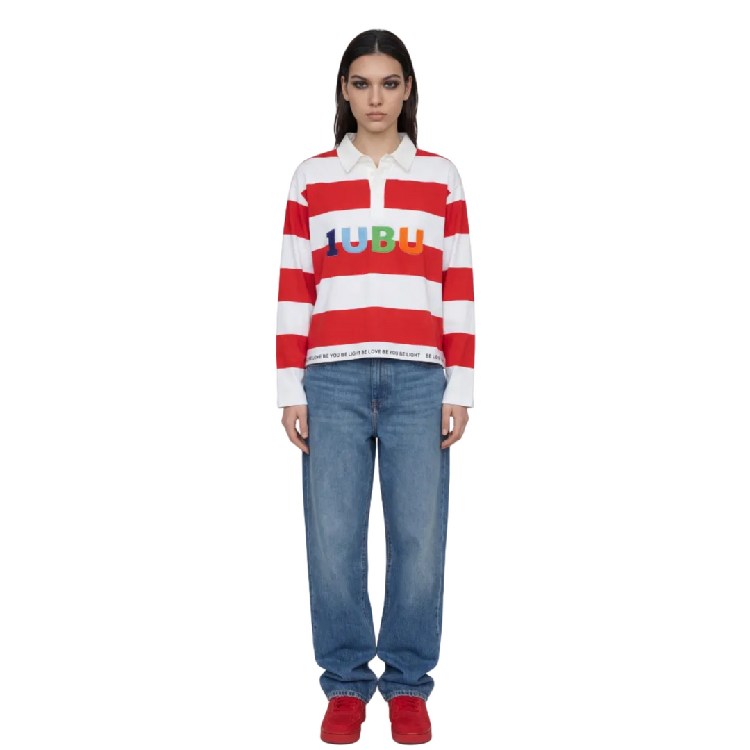 Person wearing a red and white striped shirt with colorful text and blue jeans on a white background