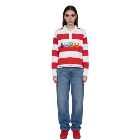 Person wearing a red and white striped shirt with colorful text and blue jeans on a white background