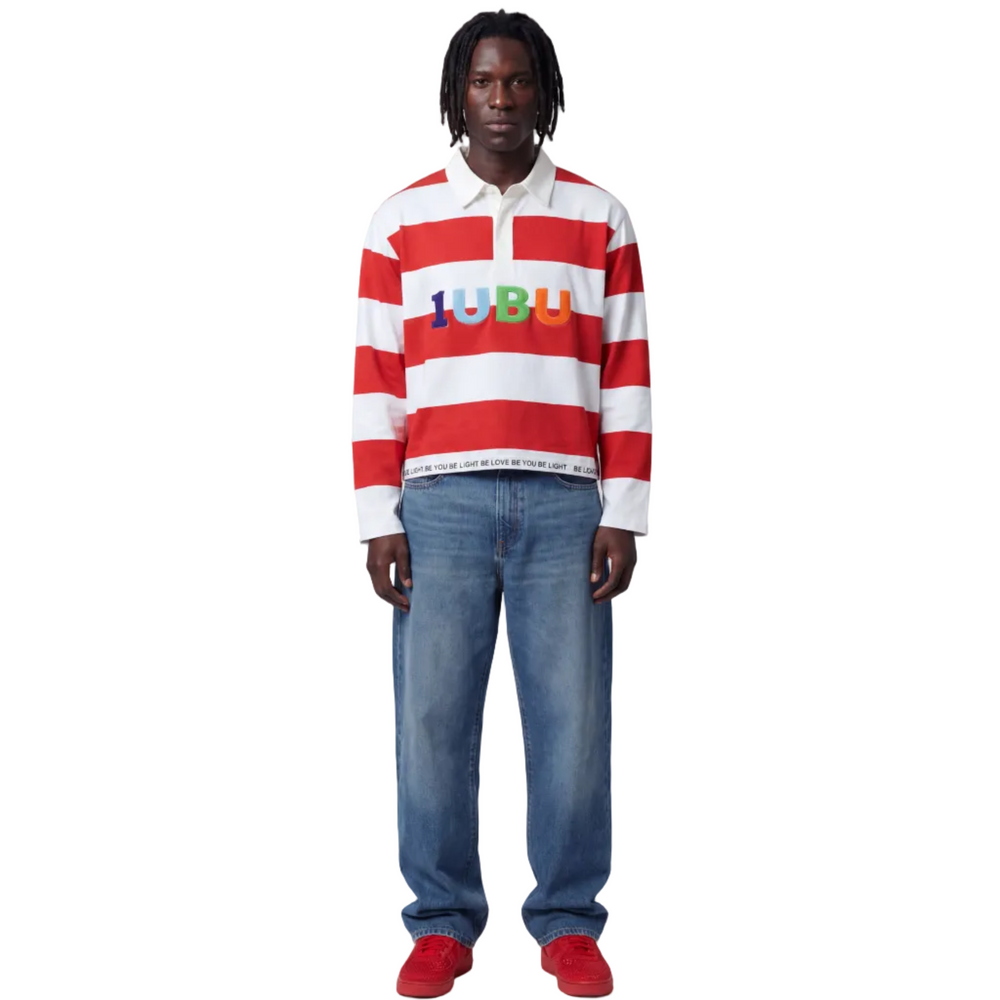 Person wearing a red and white striped shirt with 'LOULU' branding, blue jeans, and red shoes on a white background.